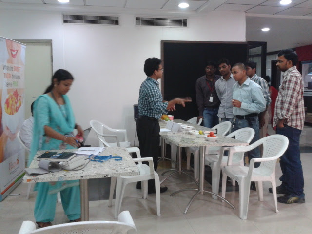 Dr. Suresh Kumar standing beside bowls of fruit at a dining table teaching practical everyday nutrition