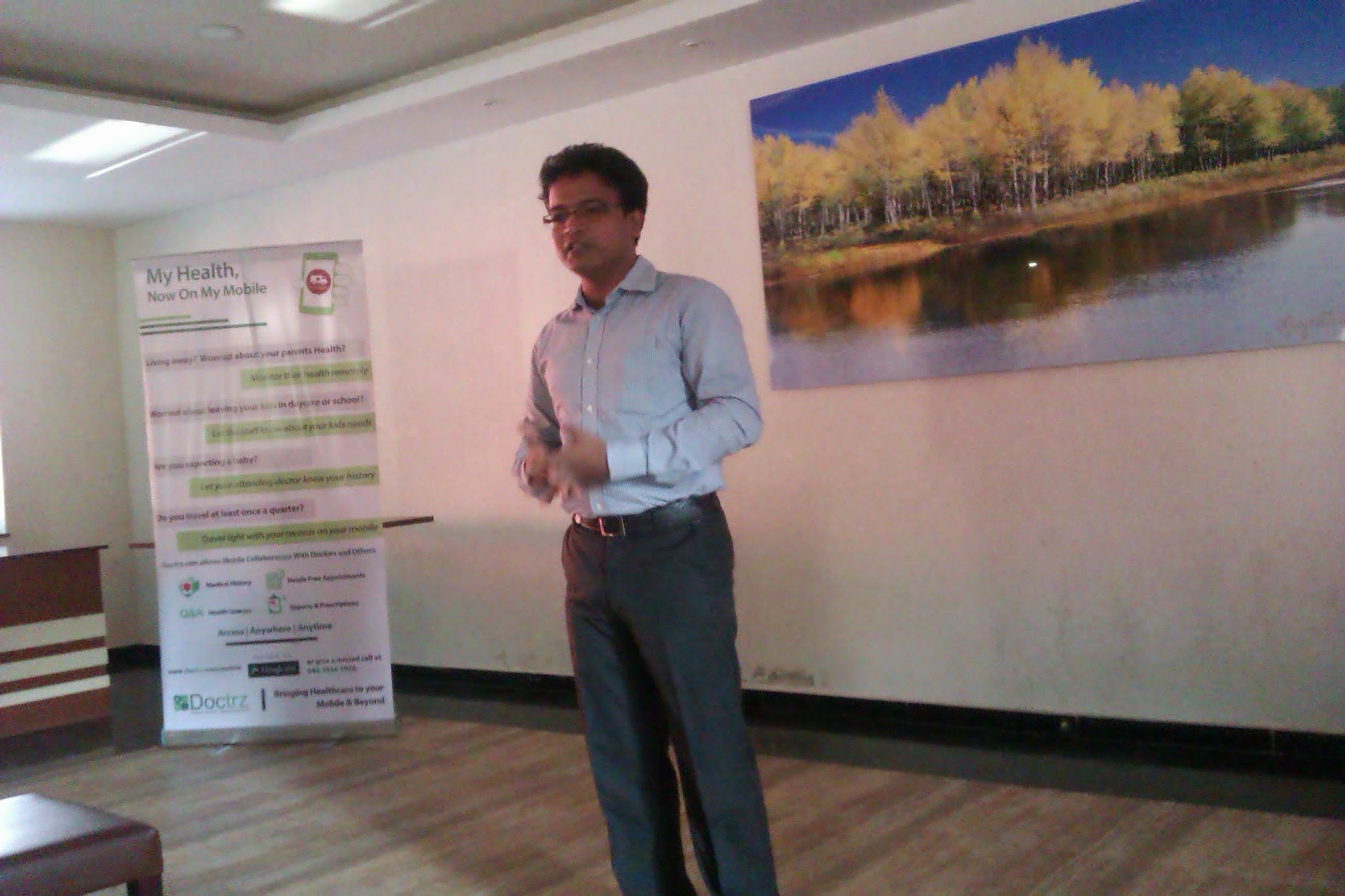Dr. Suresh Kumar standing beside the original My Health Now On My Mobile banner covering parents, school/daycare children, pregnancy, and frequent corporate travelers