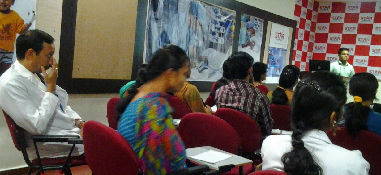 Dr. Suresh Kumar addressing physicians in white coats at Star Hospitals
